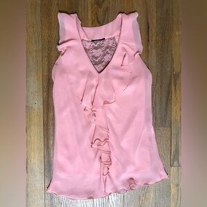 A pink, sleeveless preppy shirt
